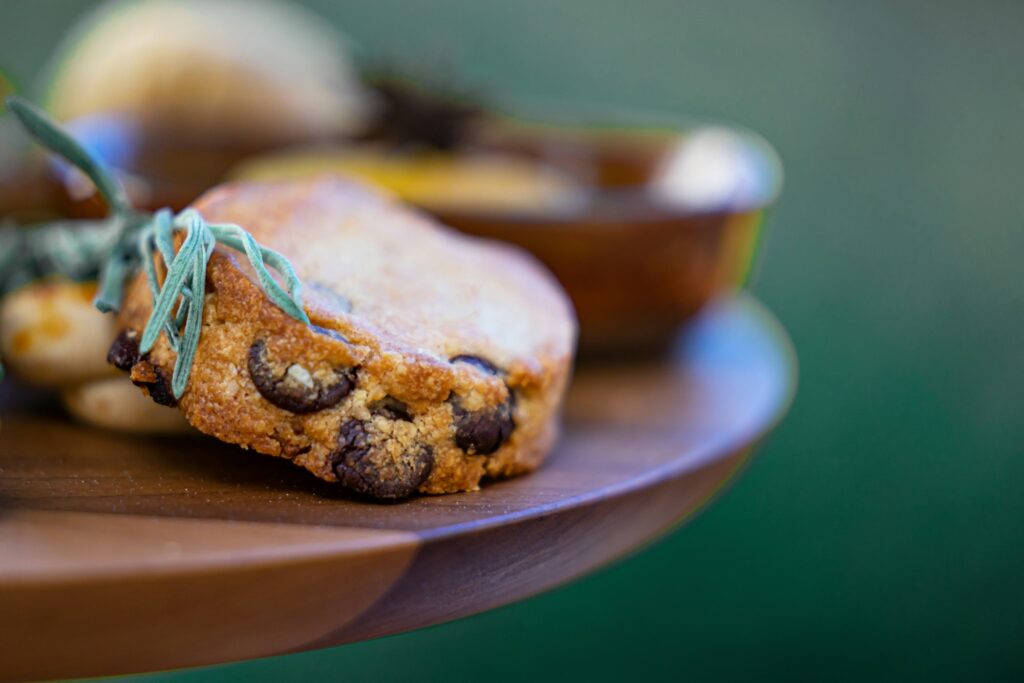 close up of assorted cookies on tray with nuts and chocolate pieces