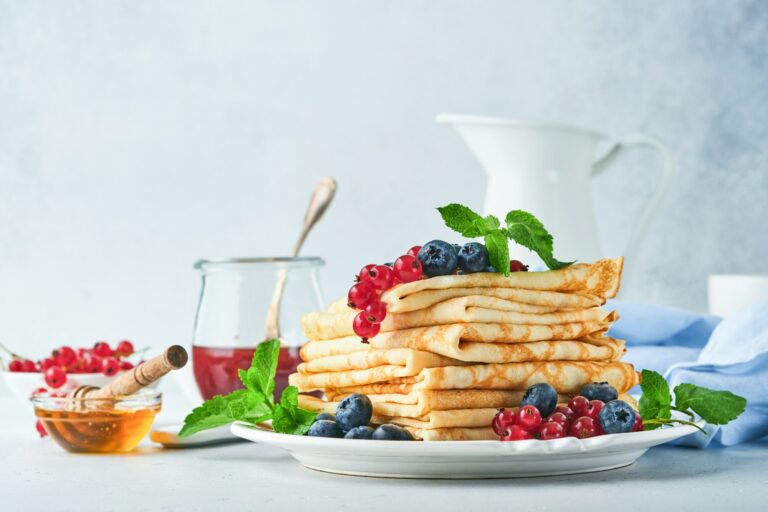 Pancakes. Stack of crepes or thin pancakes with berries, blueberries, red currants, raspberries and